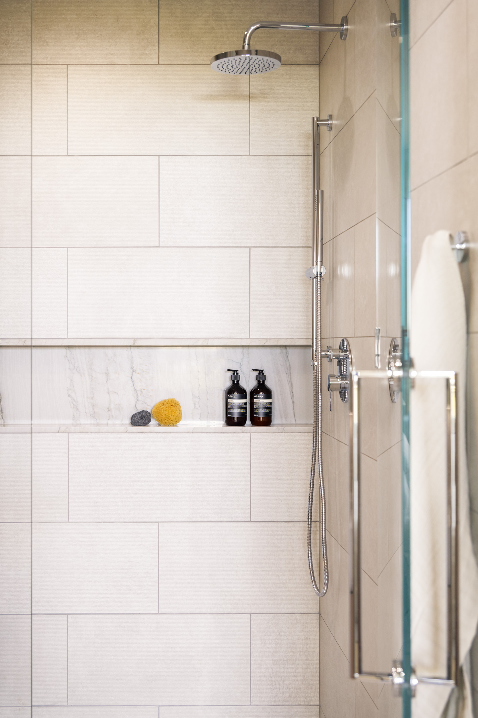 Elegant storage solutions at spa-style bathroom